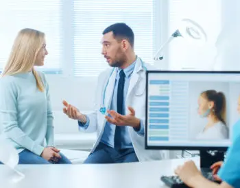 A plastic surgeon consulting a patient about a surgery she is interested in undergoing.